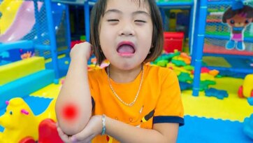 Twin Toddlers Play in Colorful Ball Pit and Giant Indoor Slides